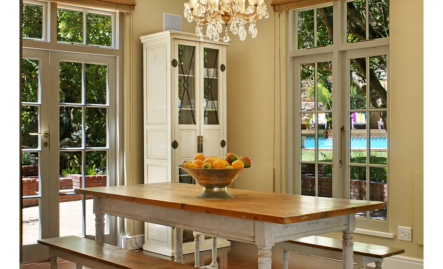 Perfect Hideaways: A beautiful coastal retreat with a spacious wooden deck, cushioned seating areas, and views of Lion’s Head rising in the background. Dolphin Cottage, Camps Bay.