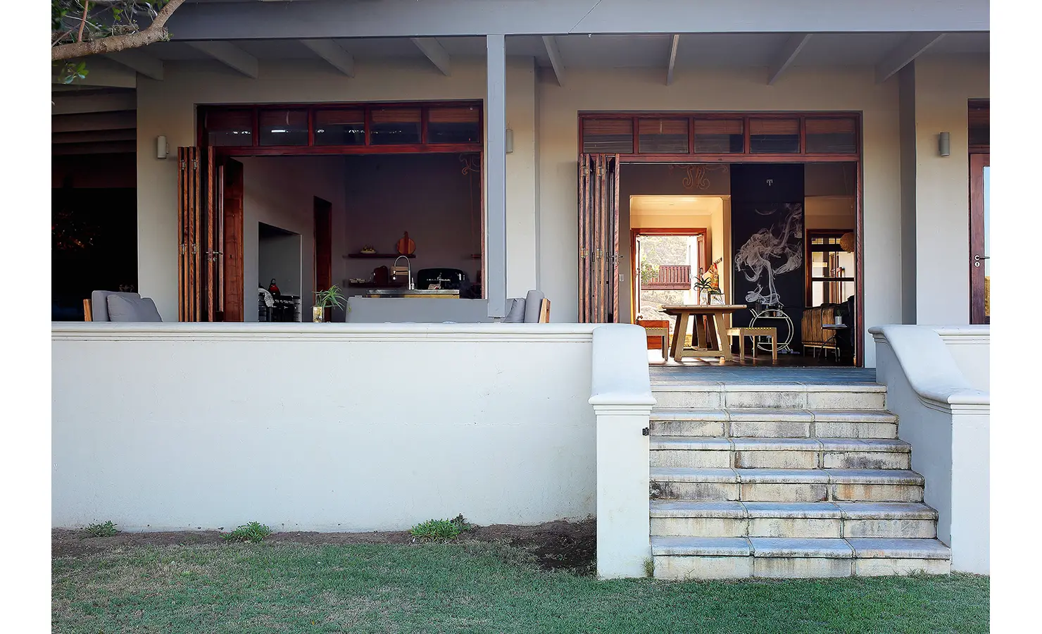 Perfect Hideaways: A close-up of the main house entrance, highlighting steps leading to a wide veranda with open wooden doors, inviting natural light into the interior. Breede Riverhouse 327, Malgas.