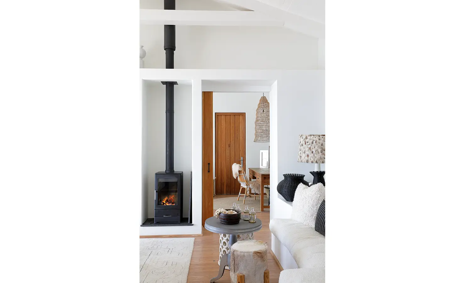 Perfect Hideaways:A cosy living room featuring a modern fireplace, plush seating, and natural accents, Ola Kala, Plettenberg Bay.