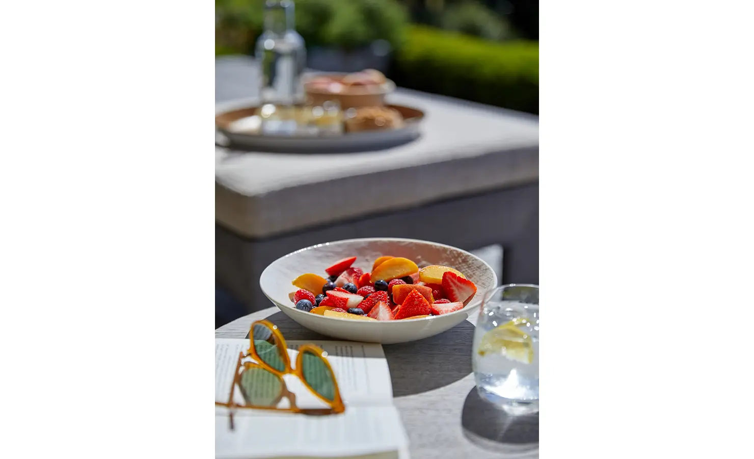 Tropical fruit platter, sunglasses and lemon water. Cliffside. Hermanus.