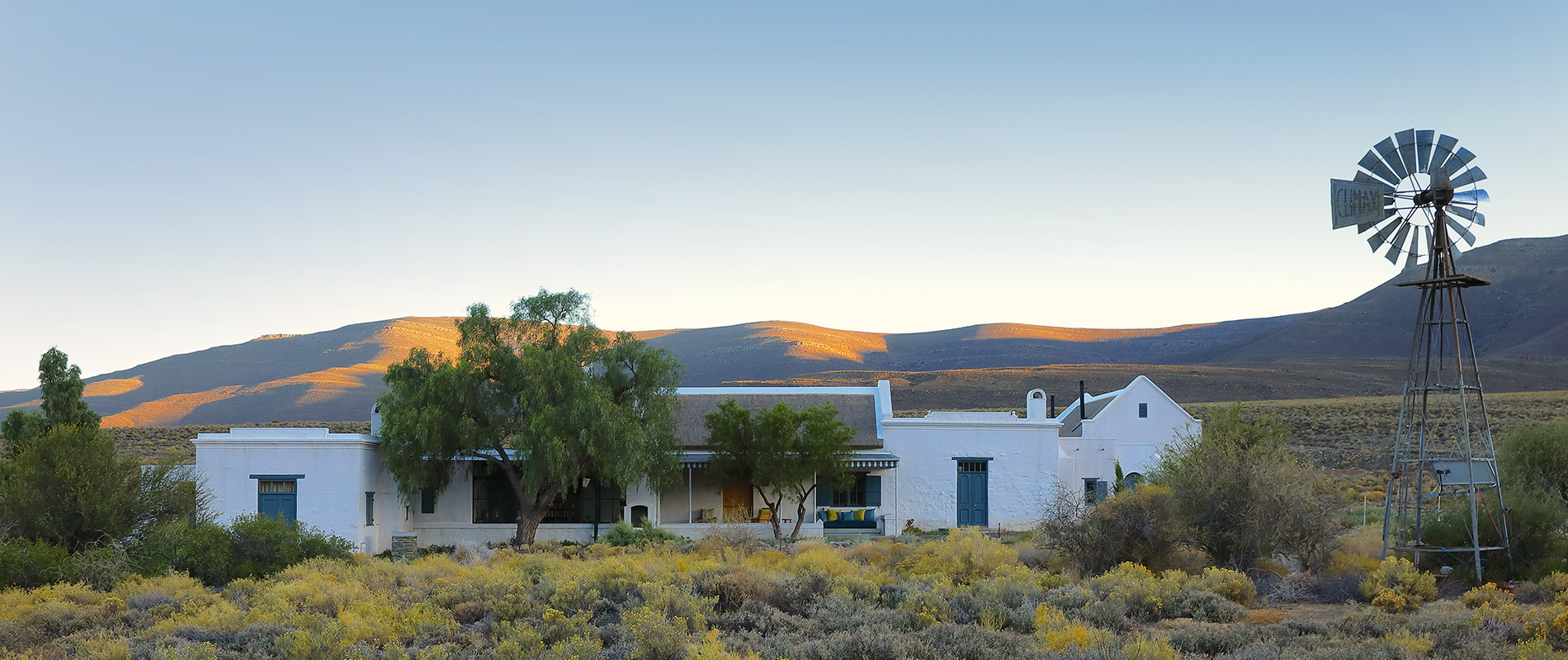 Karoo farm homestead, windmill, arid Karoo scrubland. Perfect Hideaways, De Kruis, Tankwa Karoo, Northern Cape, South Africa