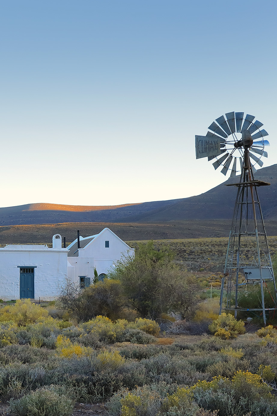 Karoo farm homestead, windmill, arid Karoo scrubland. Perfect Hideaways, De Kruis, Tankwa Karoo, Northern Cape, South Africa