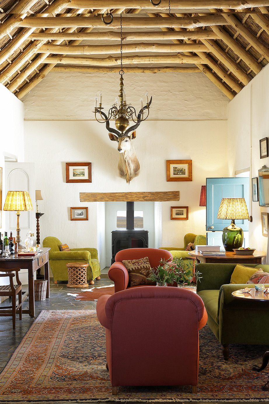 Living room with open beams and fireplace. Perfect Hideaways, De Kruis, Tankwa Karoo, Northern Cape, South Africa. Photo: Henrique Wilding