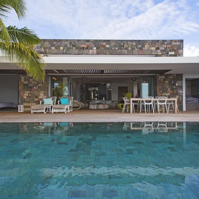 Avant-garde villa with a secluded deck and blue tiled pool.