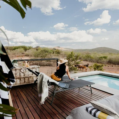 Expansive deck with sun loungers and tranquil swimming pool on the lower deck overlooking the Waterberg and National Park. The View.