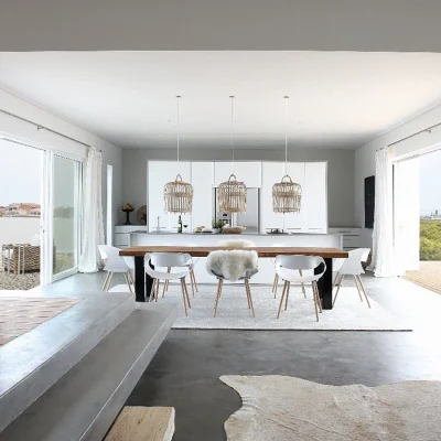 Open living area in the crisp yet calm white Feng Shui with a wooden dining table, straw hanging lights, white rugs and charcoal flooring that opens via adjacent glass sliding doors giving access to the front deck and back garden.