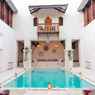 A cosseted central courtyard with whitewashed walls, arched doorways and sparkling pool facing a lounging nook. The Fort.