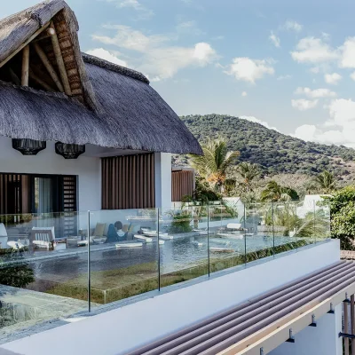 A contemporary top floor penthouse, Black River Penthouse has a thatched roof with a large terrace and swimming pool.