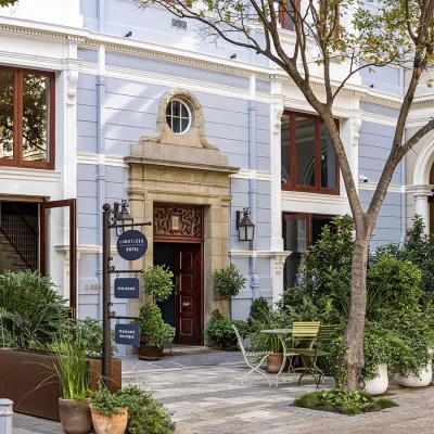 A quaint boutique hotel on the corner of Church Square, Labotessa Hotel has a historical foundation with a grand stone entrance and double wooden doors, and lifted with a light blue face and large glass windows that look out onto nurtured trees and luscious plants.