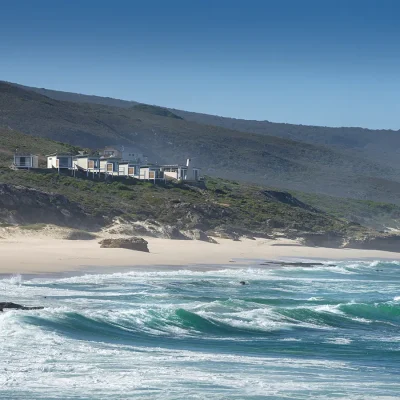 Lekkerwater beach lodge perched on De Hoop's nature reserve with a rugged landscape that meets the coastline.