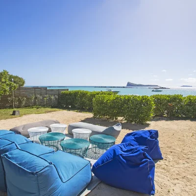 Secluded and comfortable garden seating area with views of the ocean and an island.