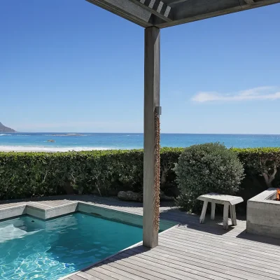 Wooden deck with splash pool, a fire pit and panoramic views of the Twelve Apostles mountain range and ocean.