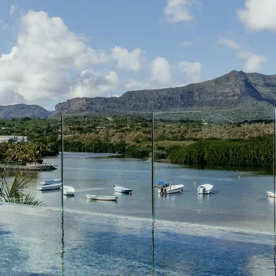 Panoramic views of the river and mountain range beneath the pool of Black River Penthouse.