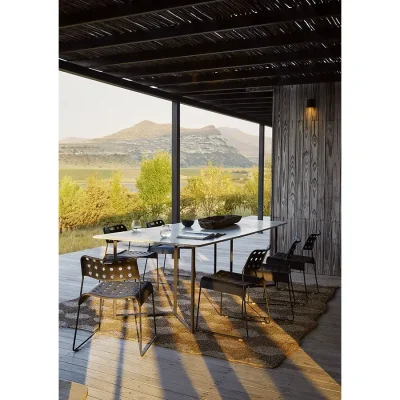 Sleek granite table on a wooden deck overlooking the vast grassy plains.