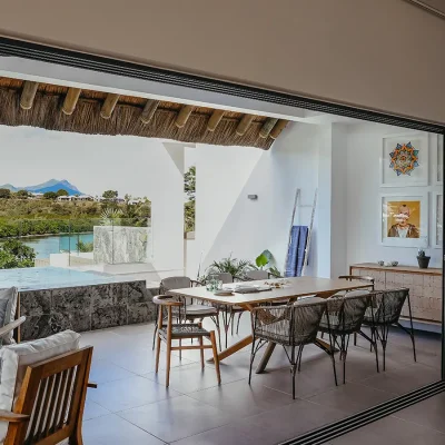 Black River Penthouse terrace with outdoor dining table and an elevated marble swimming pool that over looks a mountain range.