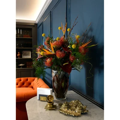 Labotessa Hotel lobby with navy blue walls, a white granite foyer table and a muted coral velvet sofa.