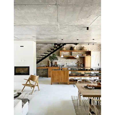 Contemporary kitchen in Pinebeach with exposed brick wall, floating wooden shelves, and wooden kitchen island surrounded by bar stools.