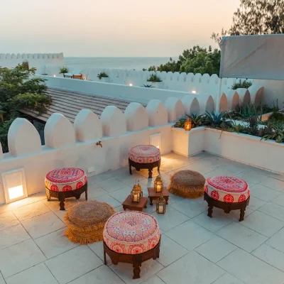 Rooftop seating on the Fort, with decorative ottomans facing the ocean.