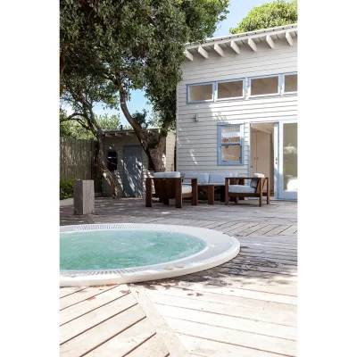 Pebbles secluded wooden deck with a built-in jacuzzi .