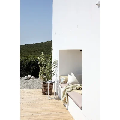 Tranquil outdoor space with a wooden deck, and a sun bed tucked into the whitewashed walls of Feng Shui.