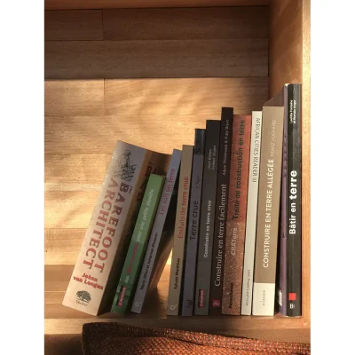 Selection of novels on a wooden bookshelf at witklipfontein eco lodge.