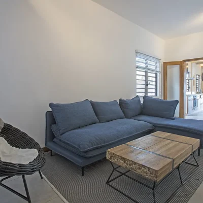 Kitchen nook containing a comfortable corner couch and coffee table.