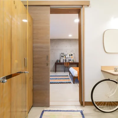 Villa De L'Ocean en-suite bathroom with authentic bathroom sink using an upcycled bicycle and sleek wooden cupboards.