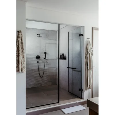 Large glass shower with grey tiles and decorated with charcoal finishes. Black River Penthouse.