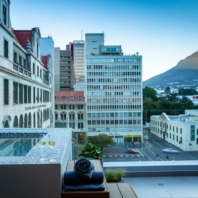 Plunge pool wwith mosaic tiling facing panoramic views of the city and Lions Head. Labotessa Hotel.