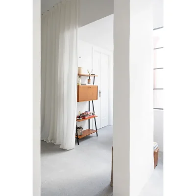 Casa Piana bedroom suite with a white column and a retro wooden cupboard.