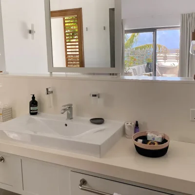 Bedroom island vanity station with hand basin and storage draws.