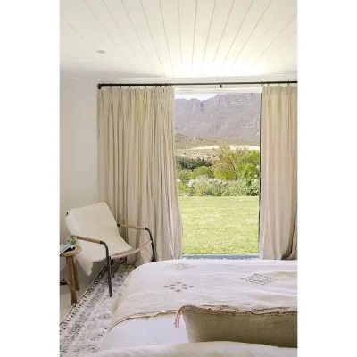 View from spacious bed with double doors exposing view of the Buchubos villa garden.