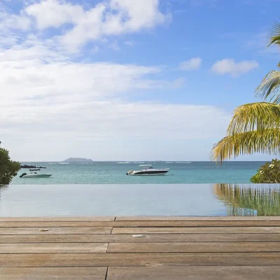 Blue hues of an infinity pool overlooking the ocean.