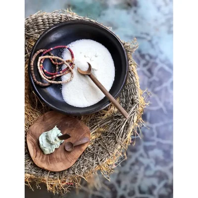 Bowls with message oils and salts, and colourful beaded necklaces. Manor House.