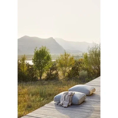 Patio with grey cushions overlooking the grassy plains and Maloti mountain range.