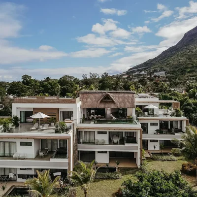 Contemporary apartment block in La Mivoie with three levels and a thatched roof.