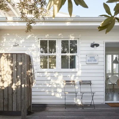 Separate entrance to Noordhoek Beach House with a wooden enclosed outdoor shower in the corner.