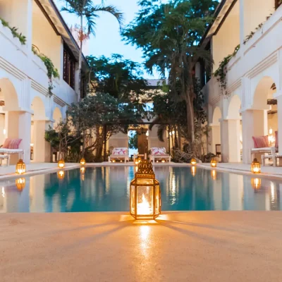 Evening at the Fort courtyard pool that reflects the warmth of the lantern lights and surrounded by impressive white arches.