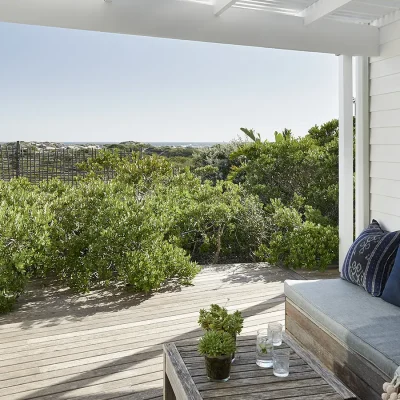 Noordhoek Beach House deck with an outdoor bench facing views of the garden and Noordhoek beach.