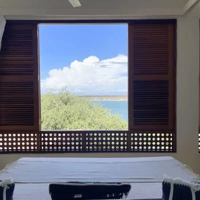 Wooden shutters opening onto the Indian Ocean. Peponi Hotel.