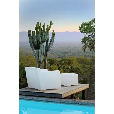 Pool with attached deck and white lounger overlooking the Waterberg terrain and mountain range.