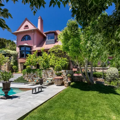 House Nouveau overlooking terraced garden and vibrant coloured pool.