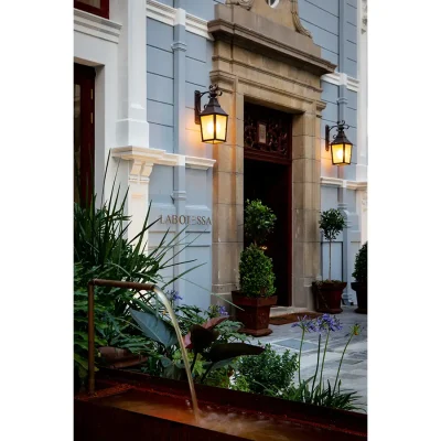 Labotessa Hotel has a historical foundation with a grand stone entrance and double wooden doors, and lifted with a light blue face.