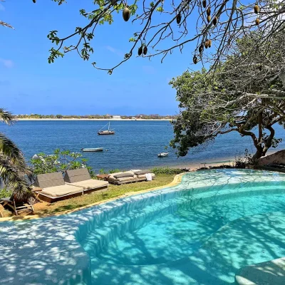 Peponi Hotel beachfront swimming pool surrounded by sun loungers.