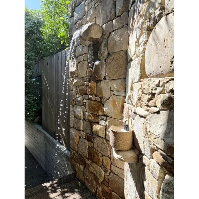 Stone wall with outdoor shower. Oasis on Glen.