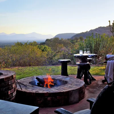 Outdoor fire pit in Manor House garden with views of the Waterberg terrain.