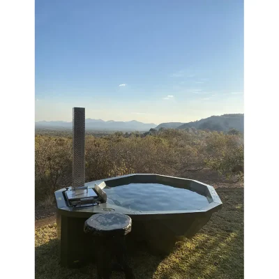 Outdoor hot tub overlooking the vast Waterberg landscape.